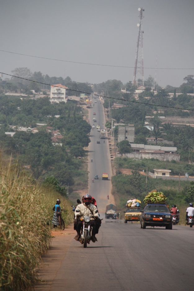 There are few paved roads in Benin so they are crowded with taxis and trucks transporting goods. 